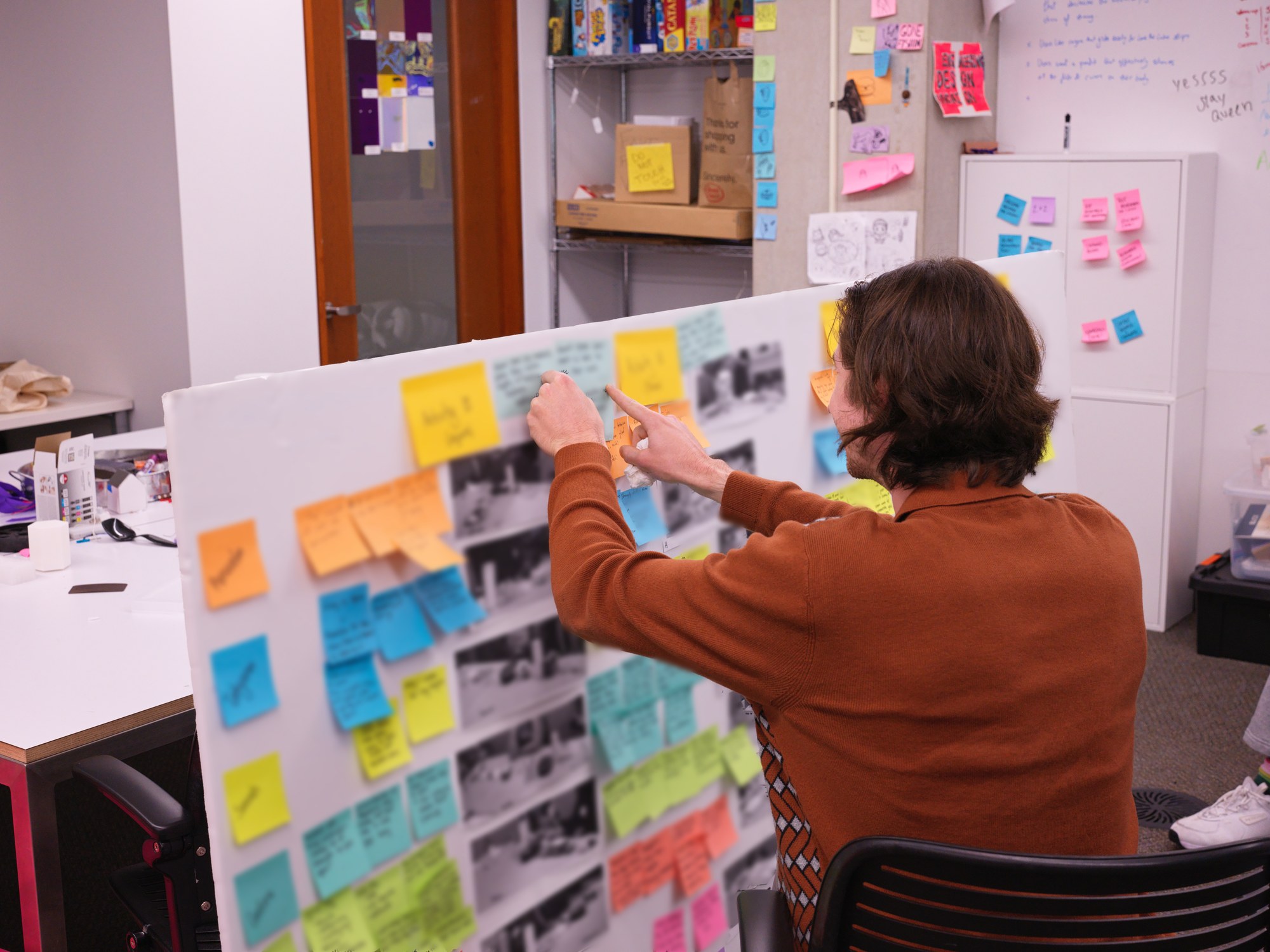 Michel Domenella synthesizing design research with sticky notes